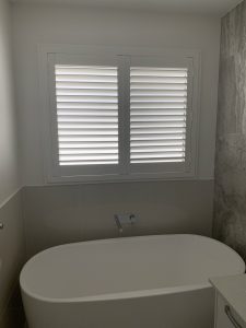 pvc shutters overlooking a bathtub