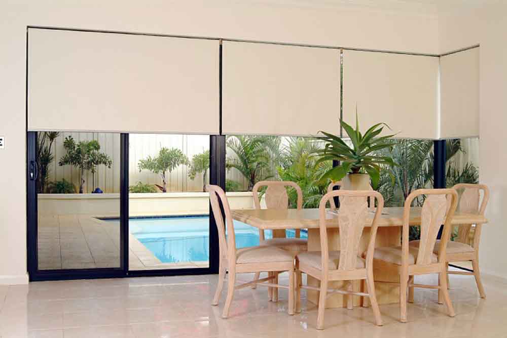 beige roller blinds in a dining room