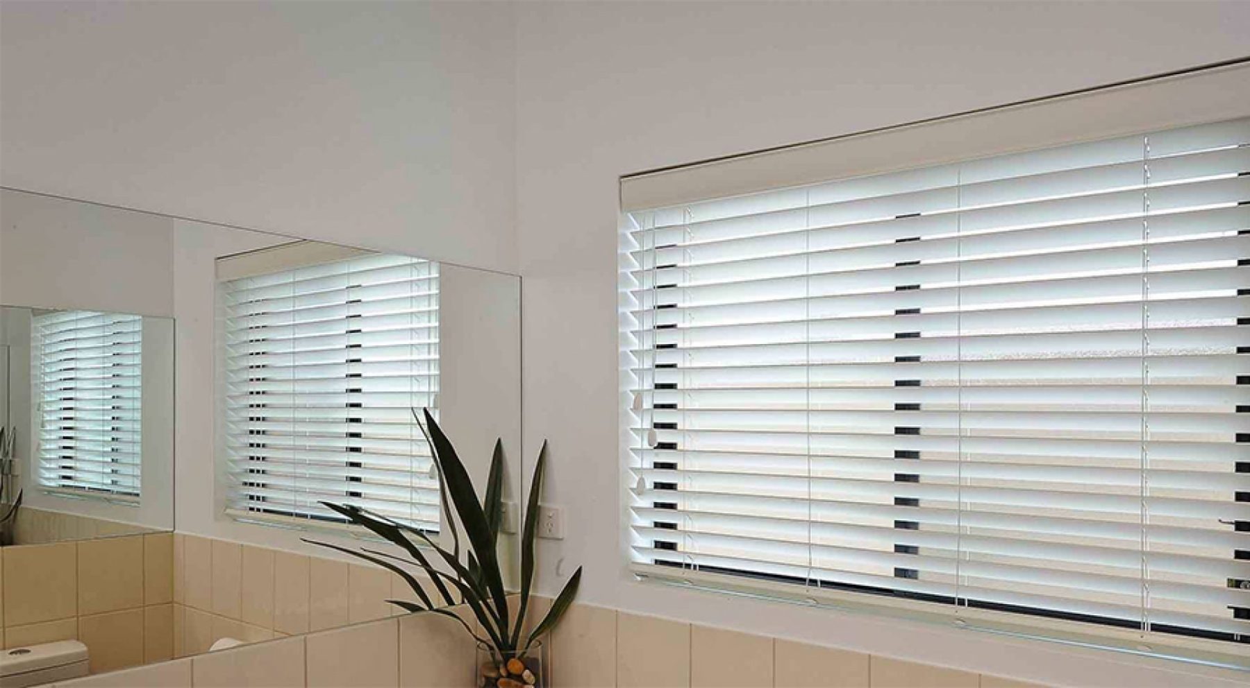 white venetian blinds in a bathroom